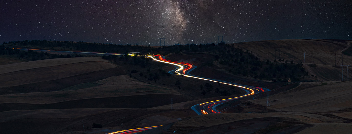 Una strada di notte con fasci di luce